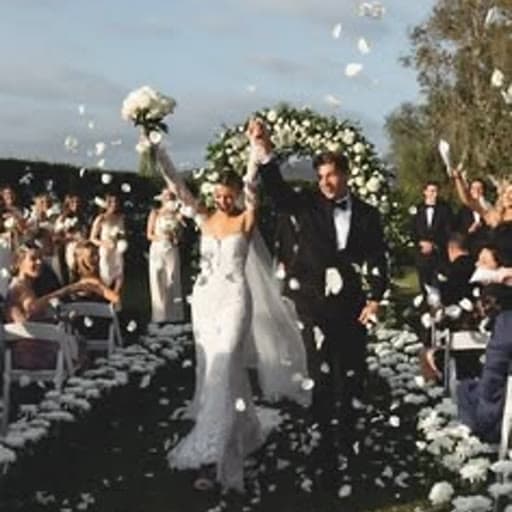 Bride and groom walking back down the aisle through a confetti toss